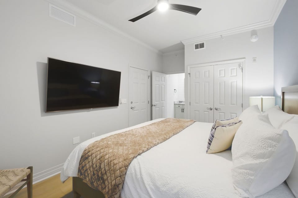 Alternate view of the king bedroom showcasing comfortable layout and wall-mounted smart TV