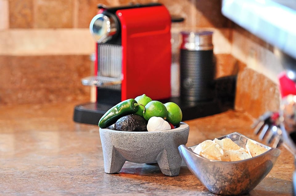 Fresh ingredients and premium coffee setup invite you to create memorable meals in your thoughtfully equipped kitchen space.