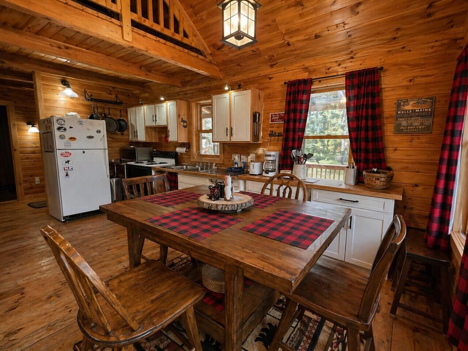 Rustic cabin dining area with cozy wood interiors, full kitchen, and warm lodge-style charm.