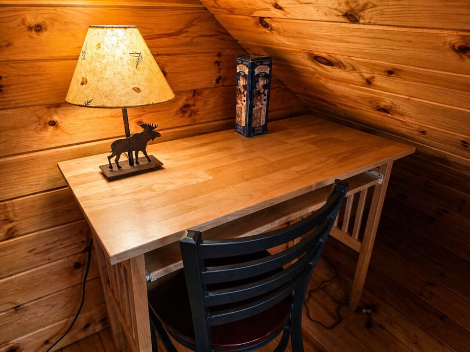 Rustic cabin loft workspace with warm wood interiors and a quiet cozy atmosphere.