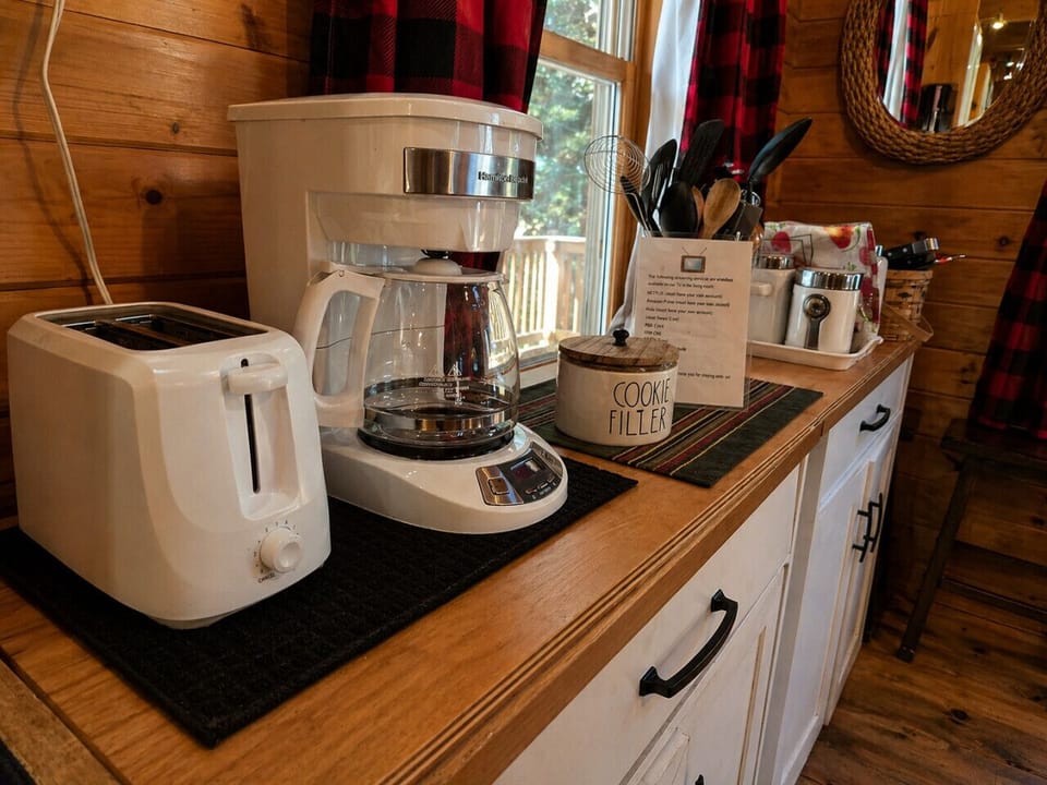 Rustic cabin coffee station with cozy lodge charm and fully stocked kitchen amenities.