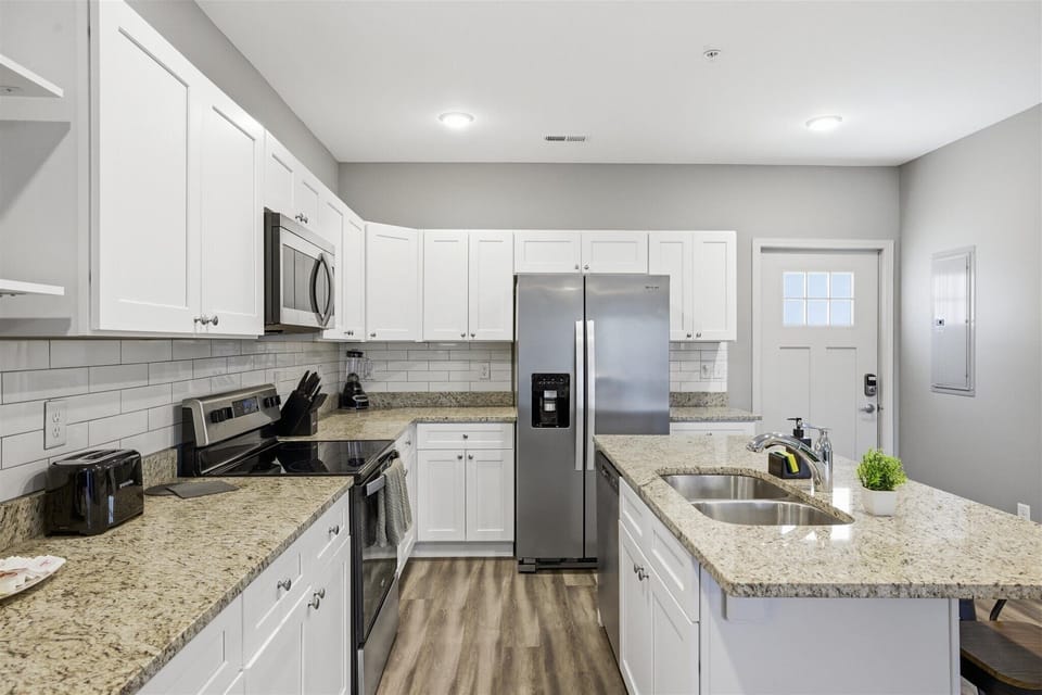Set everything out and get cooking—granite counters give you plenty of space to prep, plate, and gather. With stainless appliances and a fully stocked setup, you’re ready for anything from quick snacks to full meals.