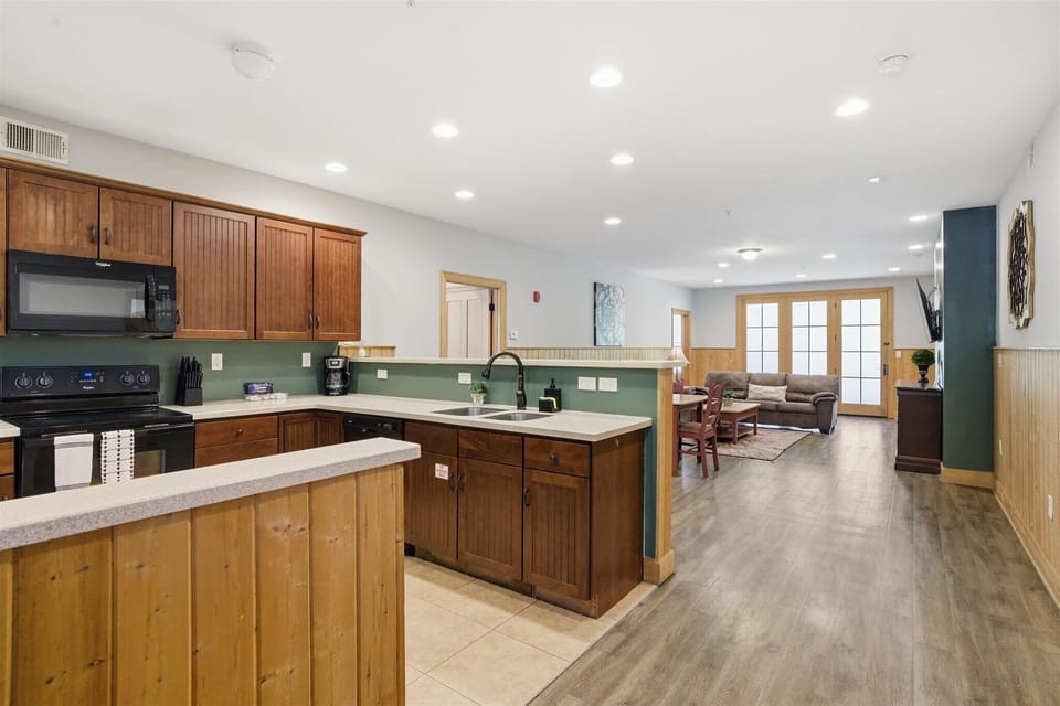 From the entry of Unit 711, the space opens wide into the kitchen, dining, and living areas, creating an immediate sense of flow, light, and connection the moment you walk in.