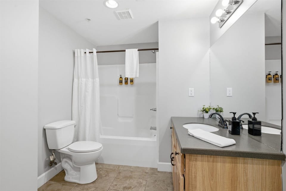 Step into this accessible king suite bathroom, where a clean, modern design and spacious layout give you room to get ready or wind down with ease after a full day.