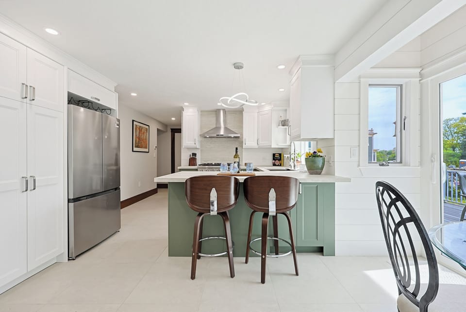 Bright designer kitchen with island seating and abundant natural light