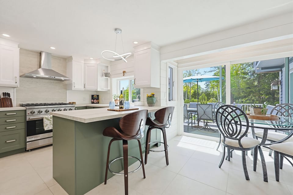 Bright modern kitchen with island seating and seamless deck access