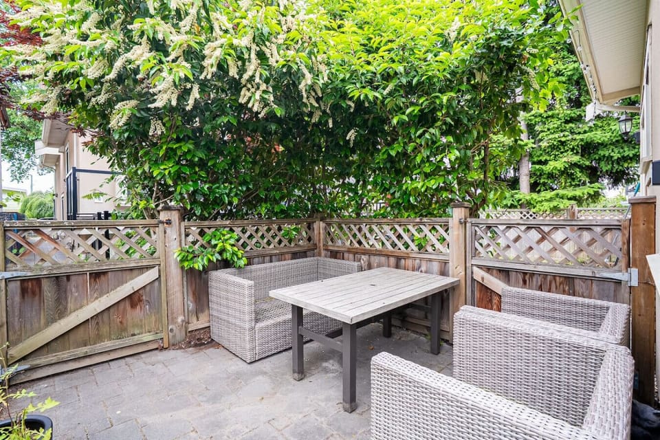 Outdoor Lounge: Tranquil patio retreat, surrounded by lush greenery for blissful outdoor dining!