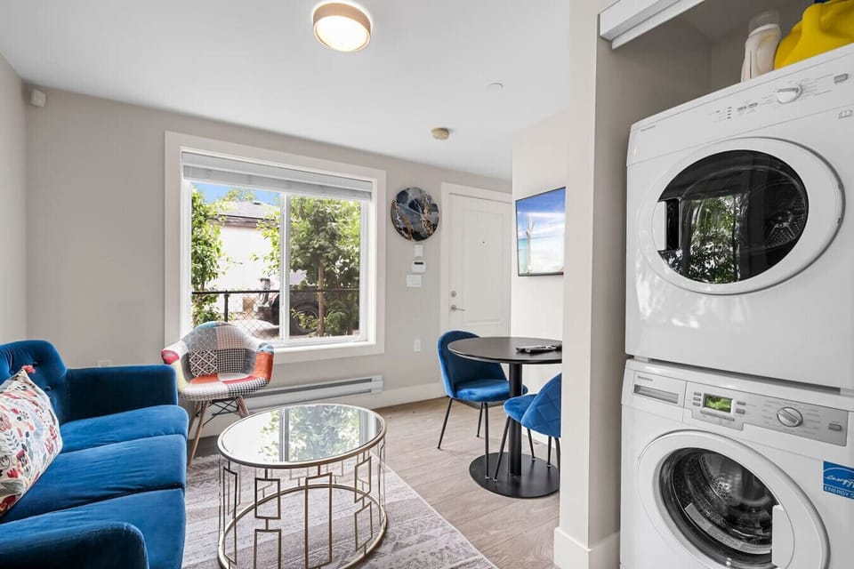 Living Room: Bright space with modern decor, in-suite laundry, and refreshing garden views!