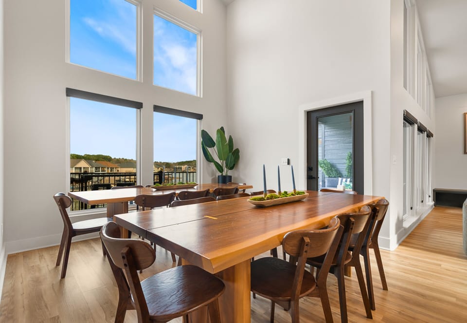 The dining area offers a welcoming space to gather around the table, with plenty of seating and natural light that makes every meal feel special.