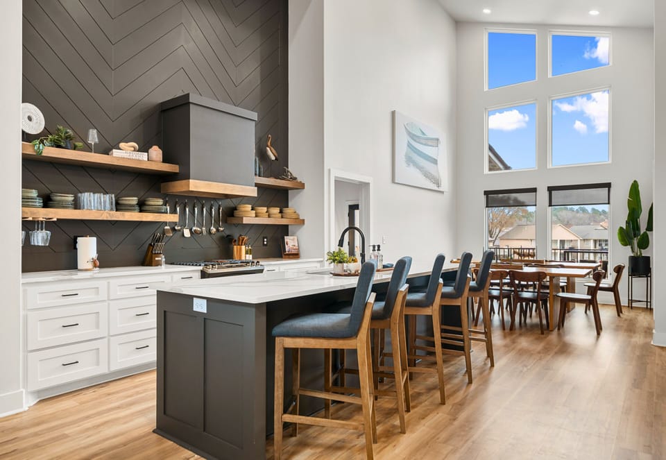 The kitchen makes a statement with its oversized island, sleek finishes, and plenty of prep space, making it just as functional as it is beautiful.