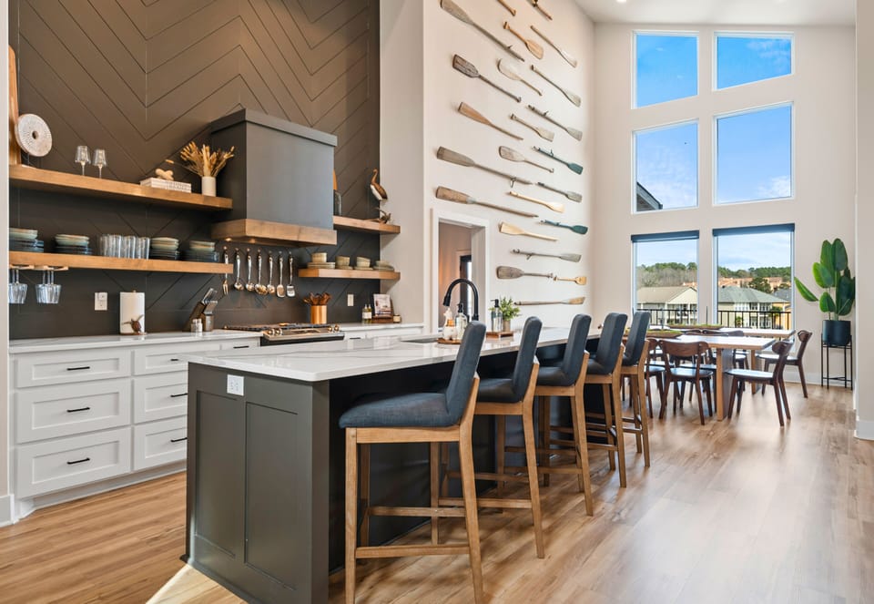 Modern kitchen featuring custom dark cabinetry, stone countertops, and high-end appliances.