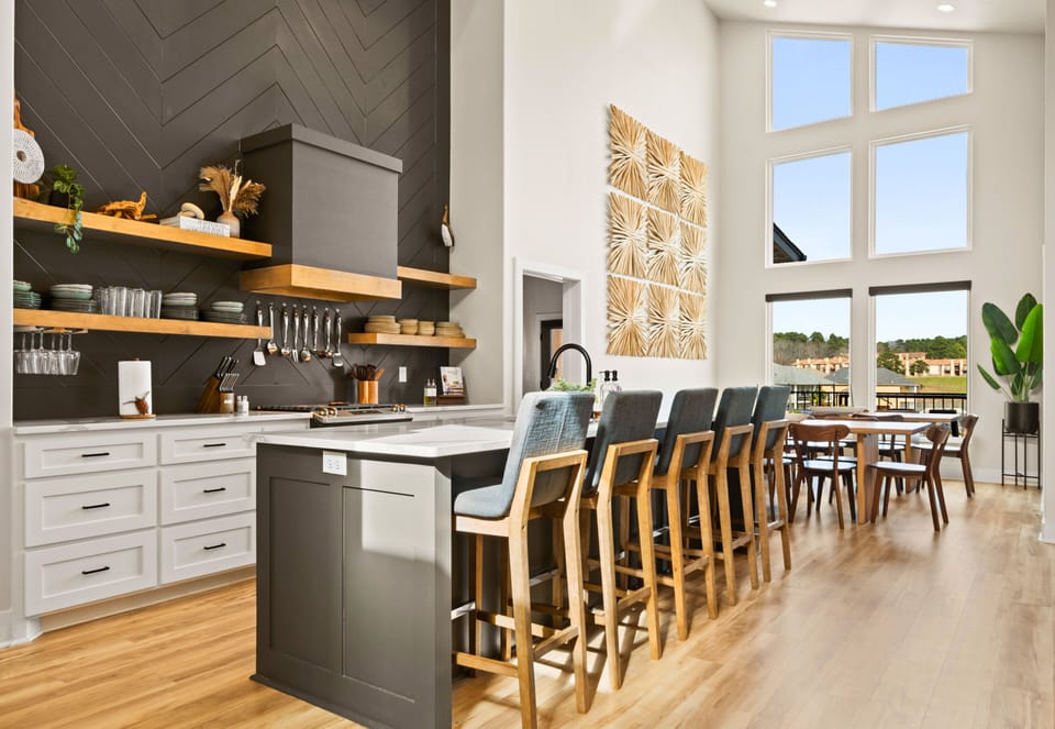 The kitchen makes a statement with its oversized island, sleek finishes, and plenty of prep space, making it just as functional as it is beautiful.