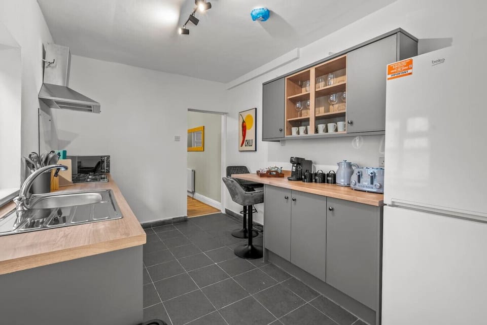 Modern kitchen with cooking appliances, storage, and counter space.