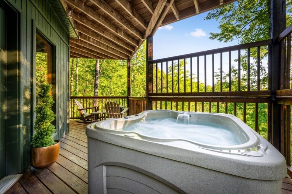 Private hot tub on the downstairs deck, right near the sauna and fire table, with relaxing wooded views after a day in Gatlinburg.