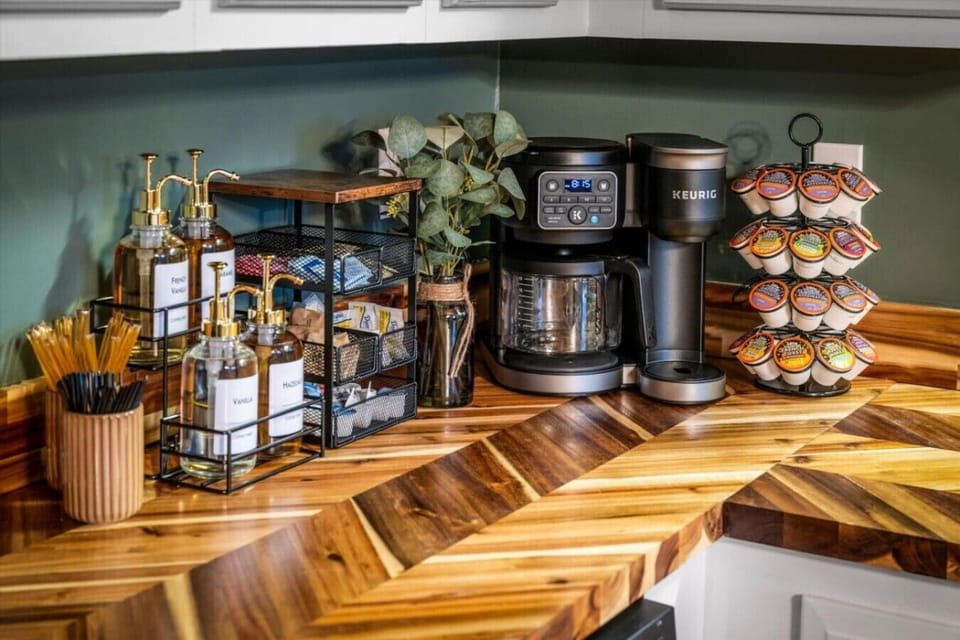Coffee and waffle bar stocked with Keurig, drip coffee, syrups, and toppings for easy cabin mornings.