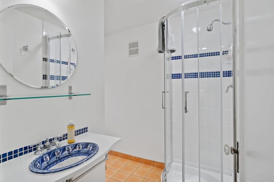 Bathroom Retreat: Indulge in refreshing showers within a stylish space featuring sleek tiles!