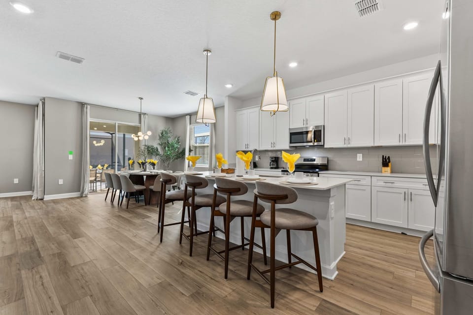 Airy chef's kitchen with quartz counters, stainless appliances, and a big island for 5-opens to the dining area and patio for effortless meals.