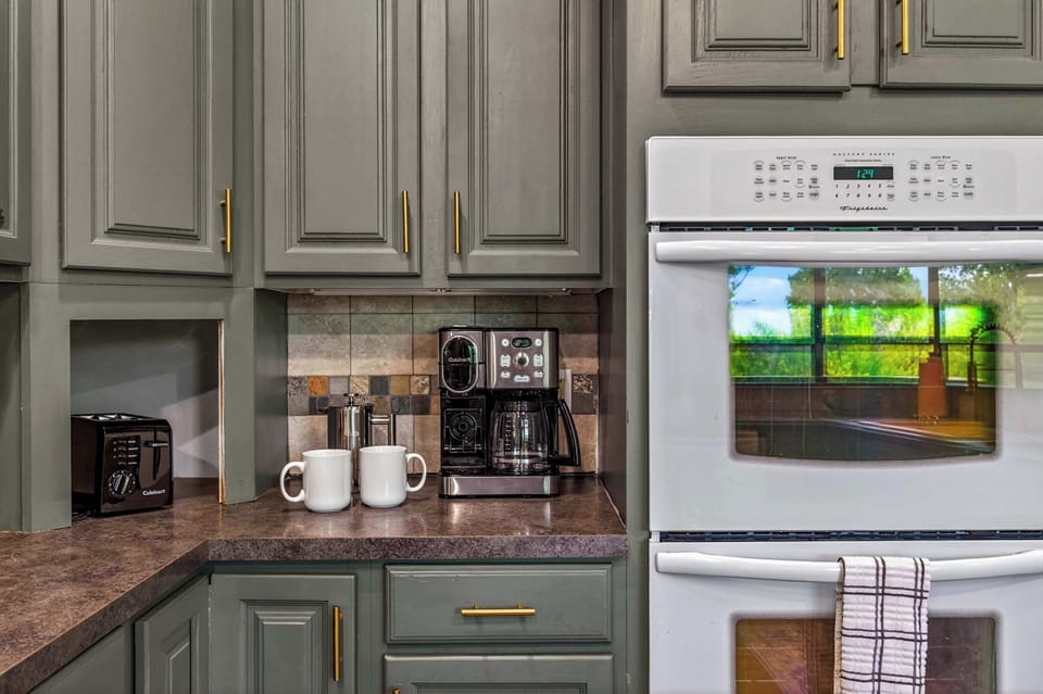 A fully stocked kitchen with top-tier appliances and plenty of cabinet space to store all your essentials. Start your mornings perfectly with the dedicated coffee station, featuring a modern brewer and everything you need for a fresh cup. 