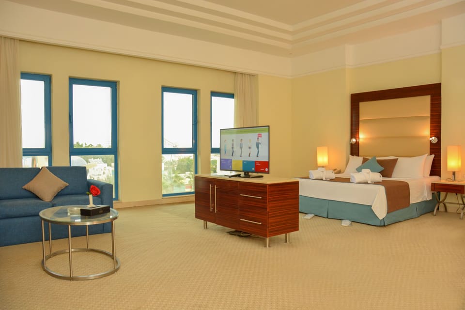 Junior Studio Suite, City View | Minibar, in-room safe, desk, blackout drapes