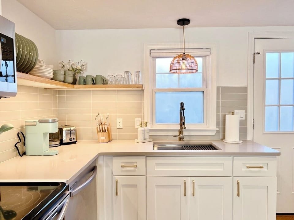 Open kitchen with plenty of dishes, utensils, and glassware for your meals