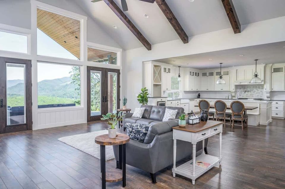 Feel right at home in the naturally lit family room with floor-to-ceiling windows and exposed wood beams.