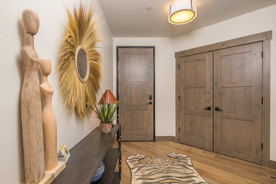 Entryway with wood doors and decor | Main Level
