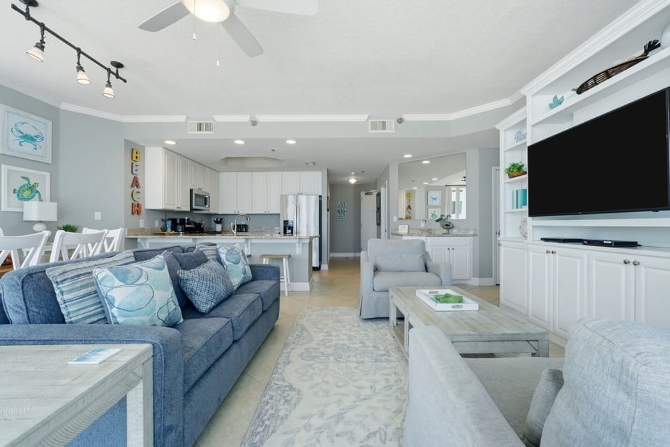 Lighthouse 418- Relax in your bright coastal haven where ocean breezes meet elegant comfort. The open layout invites you to unwind on plush seating while preparing meals and enjoying togetherness.