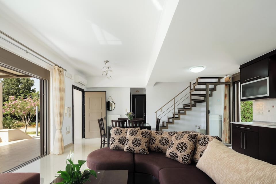The open-plan living and kitchen area also features a 6-seater dining table