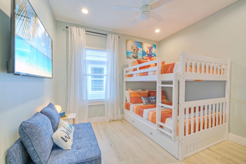 Bedroom 4 features a full-over-full bunk bed, a twin-size trundle, a full-size foldout bed, and a TV. (Flirty Flamingo)