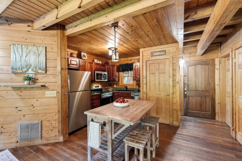 Warm, rustic kitchen with full appliances and island seating.