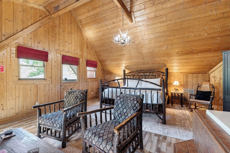 The primary bedroom features a king bed, TV, balcony, jacuzzi tub and an ensuite bathroom.
