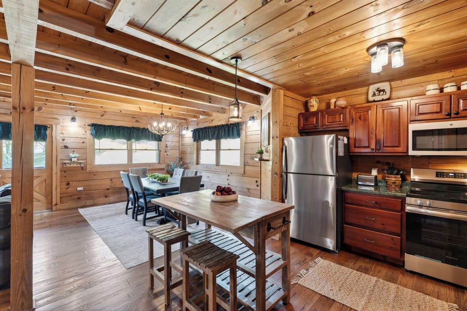 Warm, rustic kitchen with full appliances and island seating.