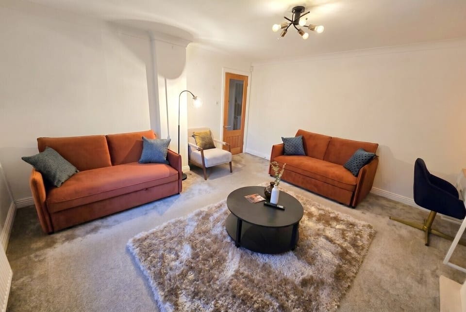 Spacious lounge seating the whole group around twin velvet sofas.