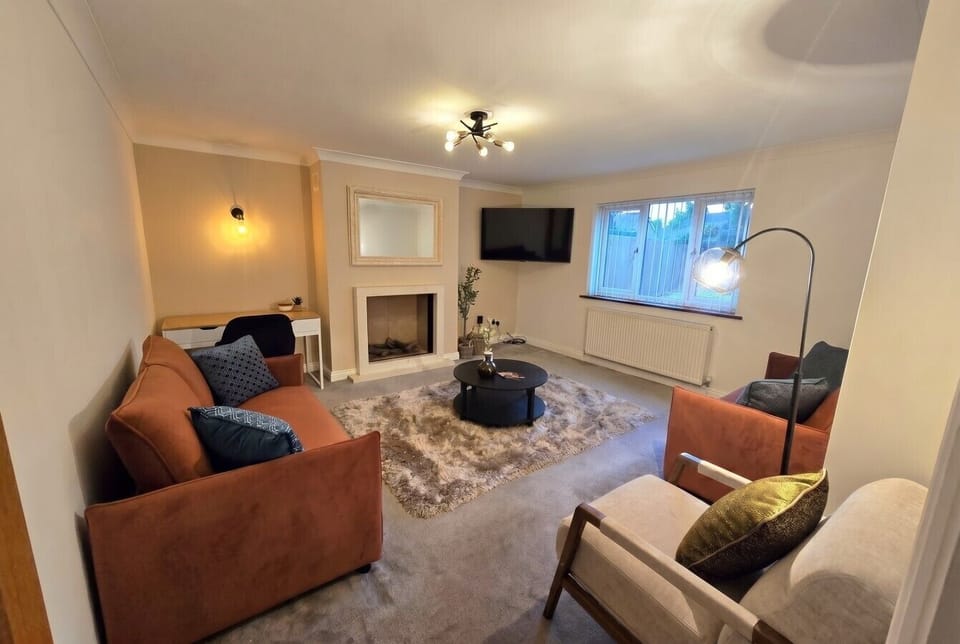 Relaxed lounge with fireplace, armchairs, and room for everyone to unwind.