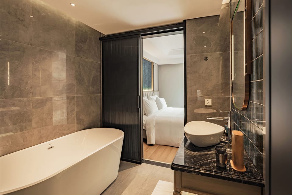 Junior Double Room, Non Smoking, Balcony | Bathroom | Separate tub and shower, slippers, soap, shampoo