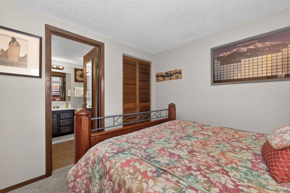 Sink into your cozy bedroom featuring a comfortable queen bed and charming mountain-themed decor that creates the perfect retreat.