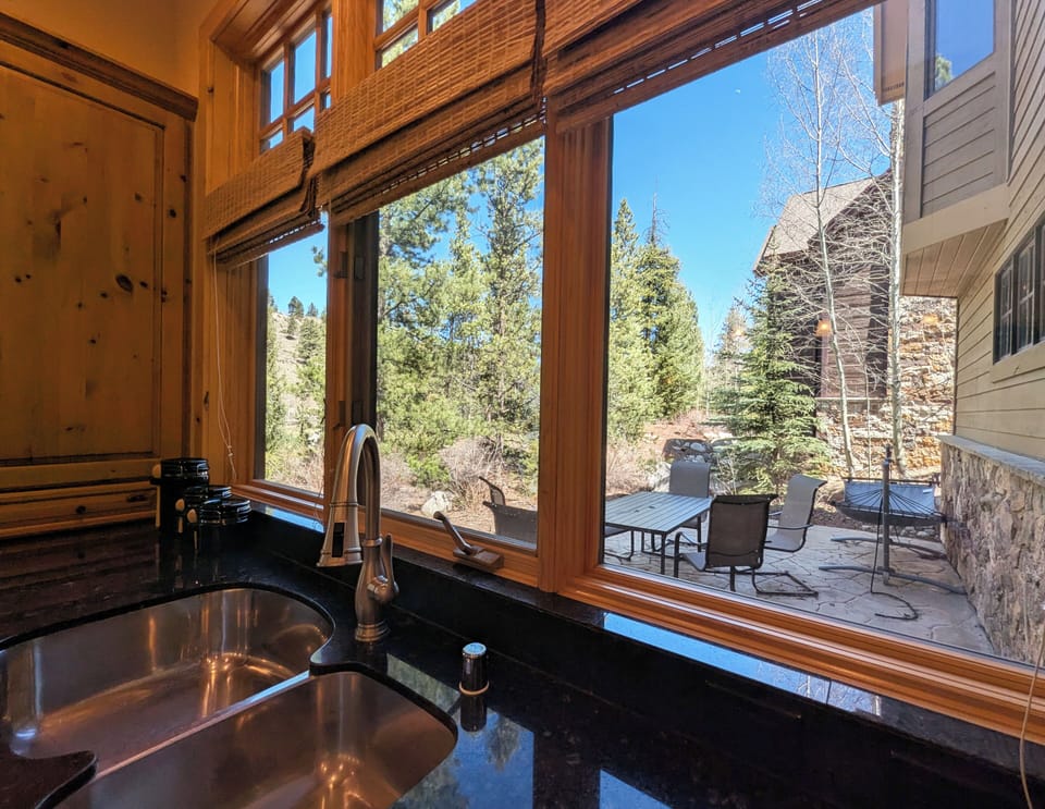 Cook with a view from your kitchen window, overlooking the peaceful patio and natural mountain scenery beyond.