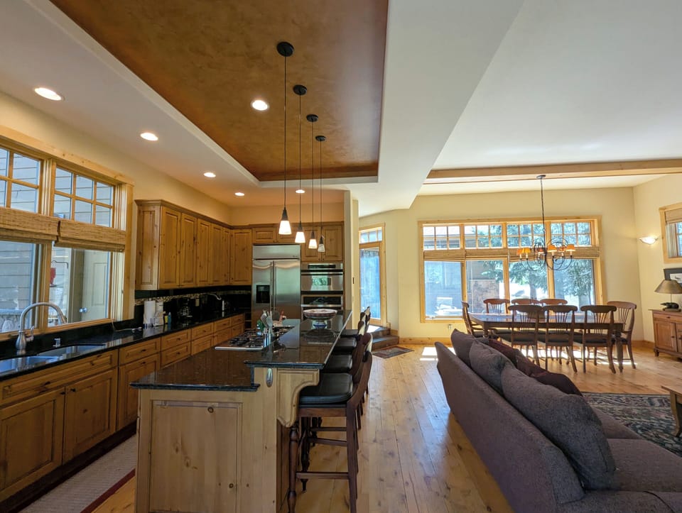 Your gourmet kitchen flows into a cozy living area, perfect for cooking together and relaxing by natural light streaming through large windows.