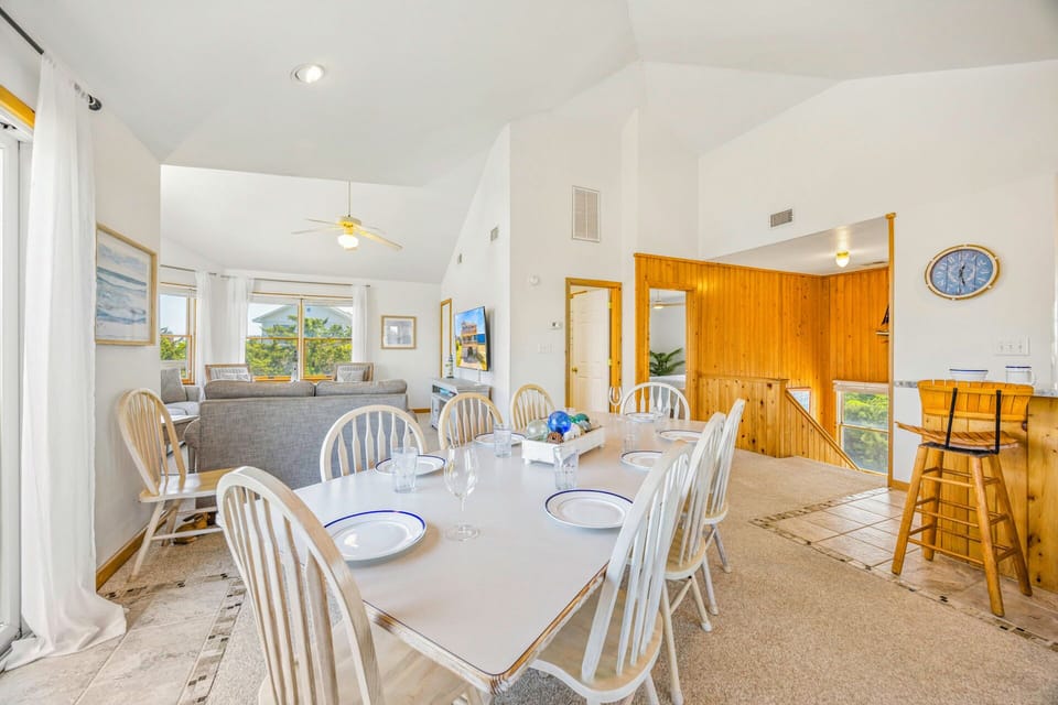 Gather your group around this spacious dining table where memorable meals and conversations unfold in your bright, open living space.