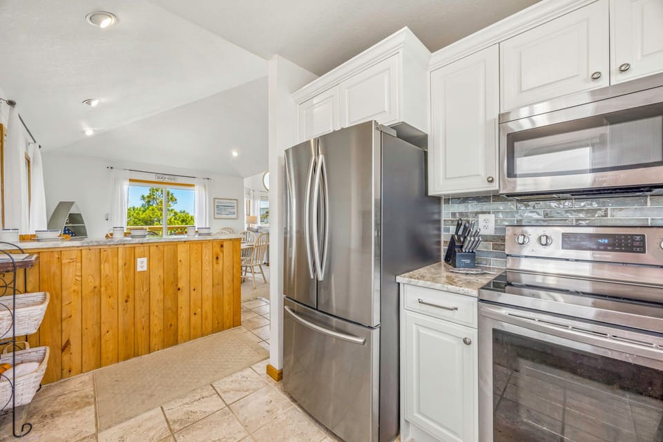 Your fully equipped kitchen features stainless steel appliances and granite counters, perfect for preparing memorable meals during your stay.