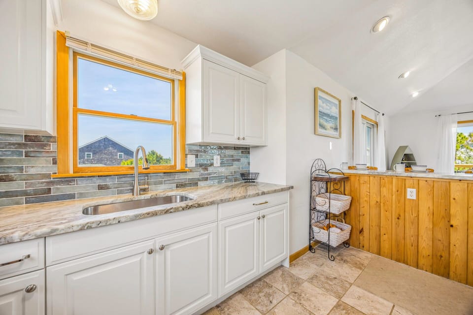 Your fully equipped kitchen features granite counters, modern appliances, and charming views - perfect for preparing meals during your stay.