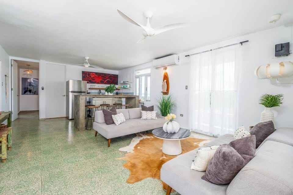 Open-concept living in Rincón, Puerto Rico — modern kitchen, cozy seating, and tropical flair for stylish island stays.