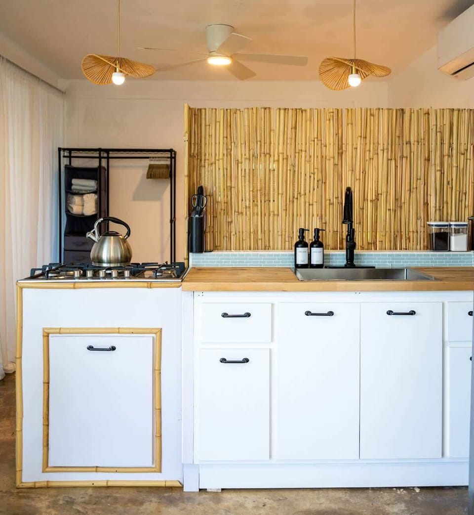 Tropical kitchen in Rincón, Puerto Rico — bamboo accents, minimalist design, and modern flair for island-style stays.