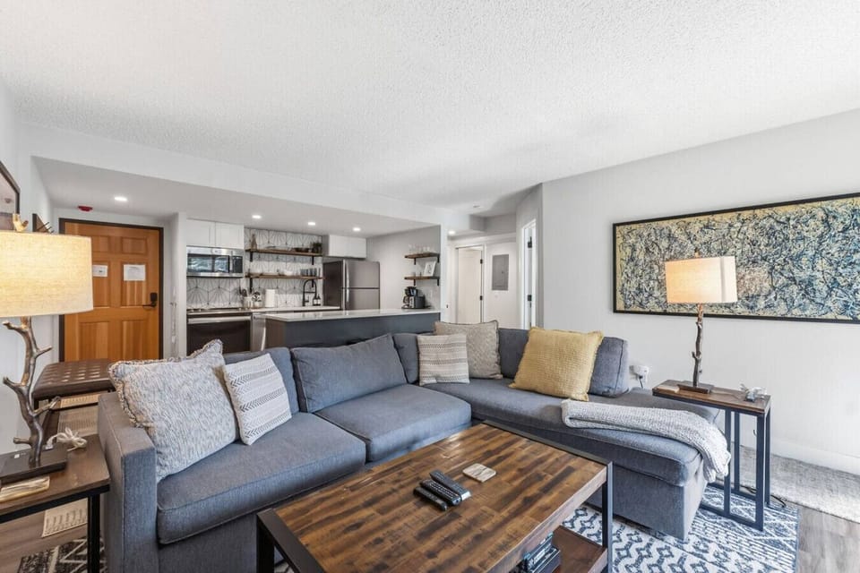 Living room with smart TV, fireplace, and pullout sofa