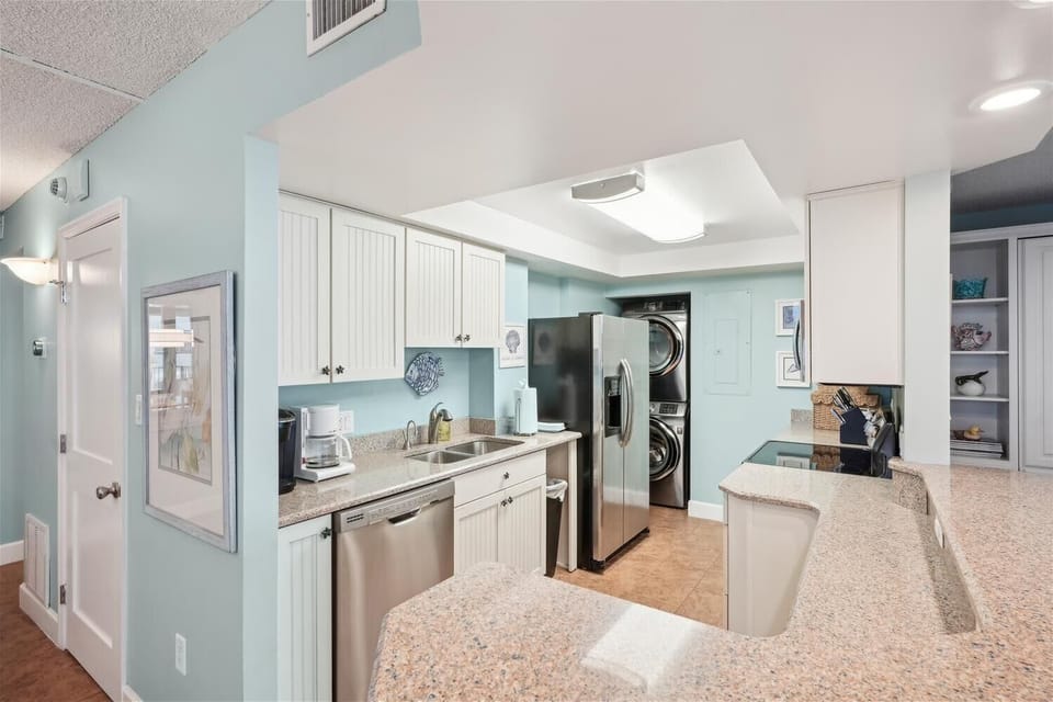 Your fully-equipped kitchen features modern appliances, granite countertops, and a convenient in-unit washer and dryer, making your vacation stay effortless and comfortable.