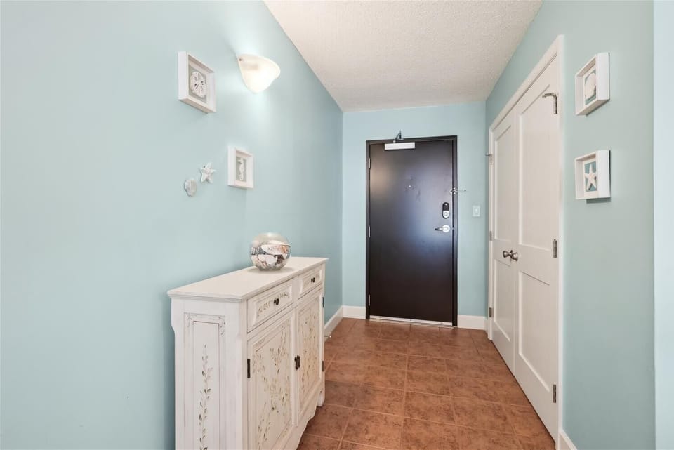Your welcoming entryway greets you with calming blue tones, coastal décor, and charming personal touches that instantly make you feel at home.