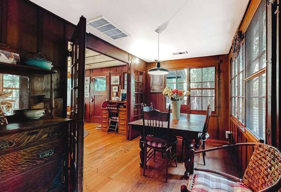 Host your own wine-country dinner party in this character-rich dining room — an antique hutch, warm wood paneling, and seating for the whole group.