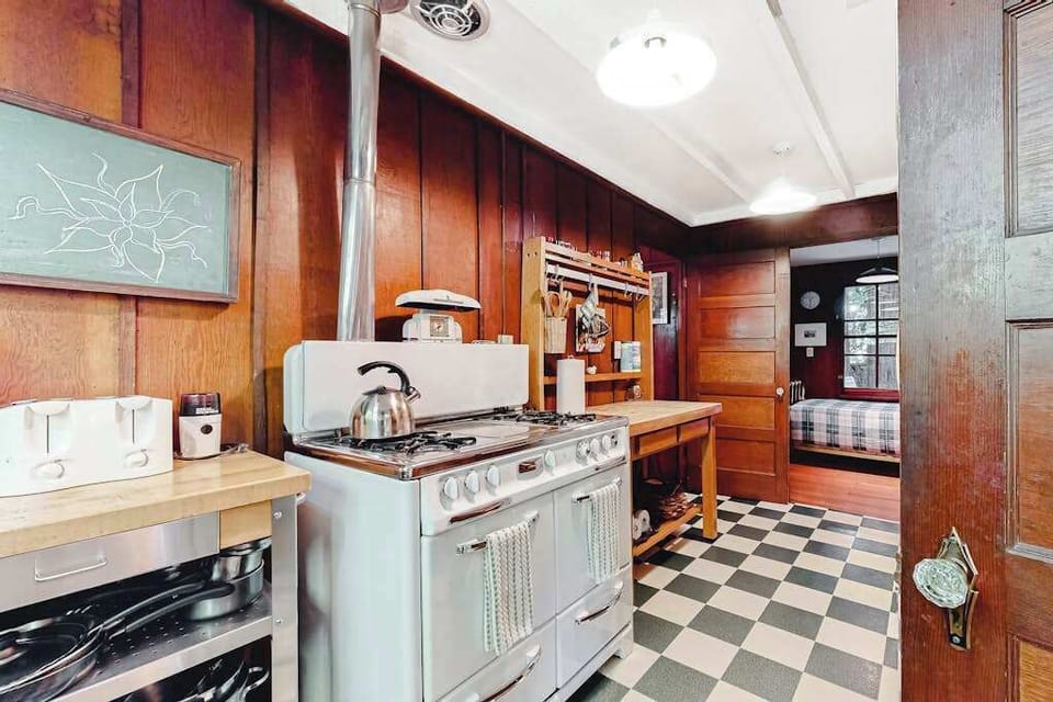 Channel your inner chef at the vintage range — your retro-chic kitchen has a toaster, kettle, and all the tools for a redwood-cabin feast.