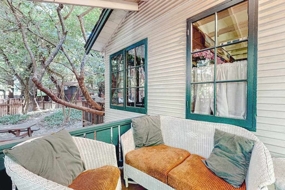 Kick back on your covered front porch with a glass of local pinot — cushioned wicker seating and a leafy canopy make this your favorite morning spot.