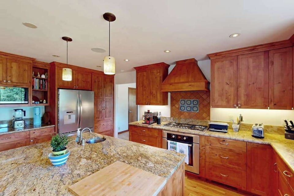 Cook with everything you need — a pro-style gas range, stainless steel appliances, and custom cherry cabinetry make meal prep a pleasure between vineyard visits.